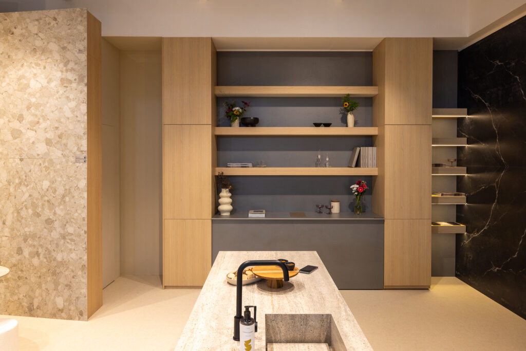 Isola cucina con top in lastra e boiserie in legno, stand Infinity Area30 2026 – Progetto 2